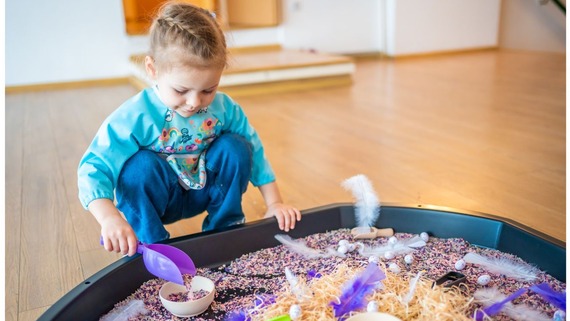 child playing with a sensory tray