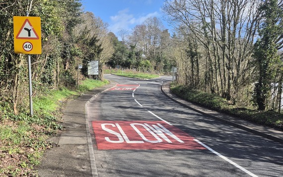 the approach to the old war memorial junction in Finchampstead, with slow markings and the centre lines clearly repainted