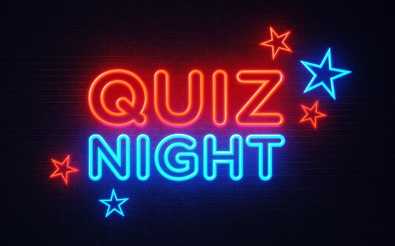 Neon sign reads QUIZ in red above NIGHT in blue on a dark brick wall. Red and blue neon stars around the text.