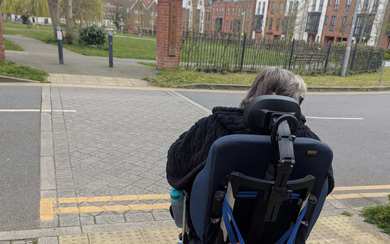 Woman in a wheelchair at a crossing point