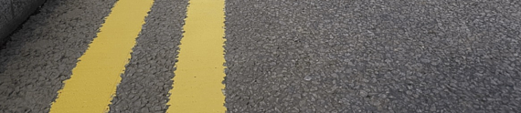 close-up of double yellow lines on a road