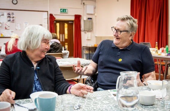 Two people smiling in discussion