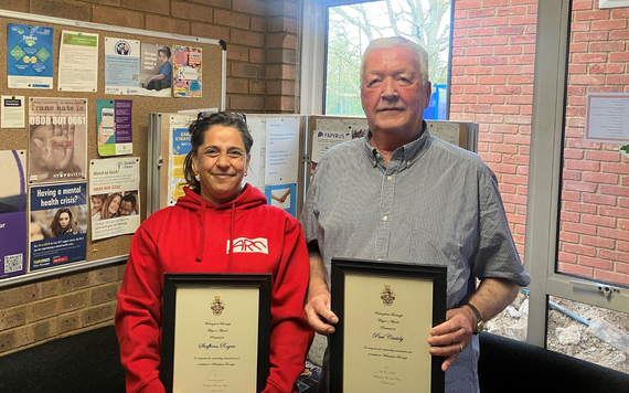 Shaffrina Rogers and Paul Cassidy holding their awards