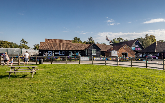 The buildings at Holme Grange Craft Village, with a large grassy picnic area in front
