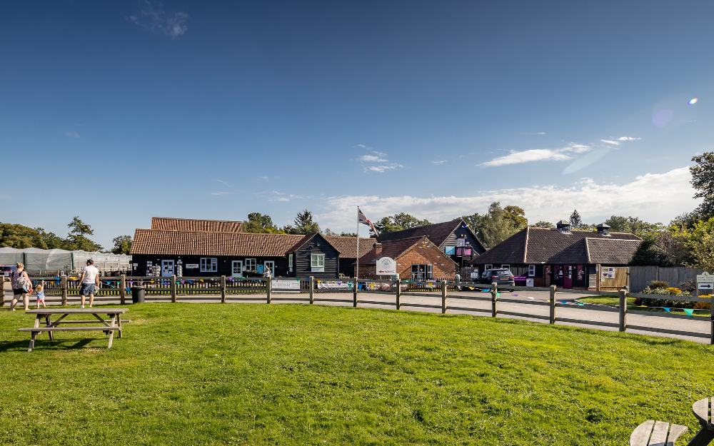 The buildings at Holme Grange Craft Village, with a large grassy picnic area in front