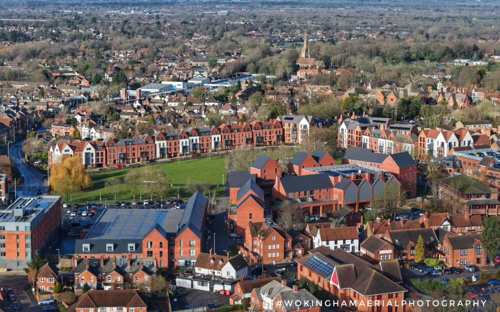 An aerial drone photography showing the rooftops, spires of Wokingham, overlooking Elms Field