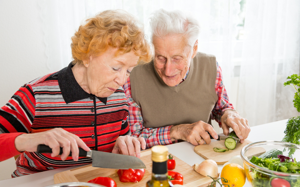 Older couple chopping vegetables