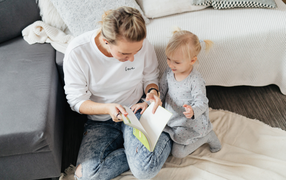 Mother and toddler reading book