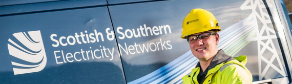a female engineer for Scottish and Southern Energy Networks (SSEN) poses with a branded van