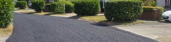 the surface of a newly dressed road, with a top layer of stone chippings clearly visible