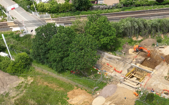 aerial view of a road being built, with very deep excavations on the site that are reinforced with wooden beams