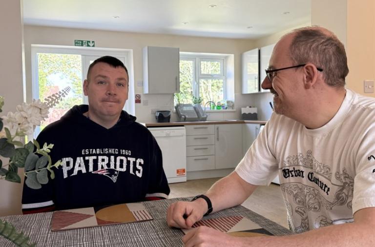 Colin and Jon sat at a kitchen table