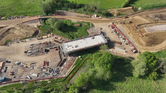 The foundations of a bridge are lowered into a place as teams build a new road through a field at South Wokingham