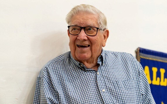Gordon smiling, wearing glasses and a blue chequered shirt