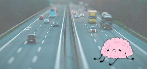 cartoon of a brain looking exhausted over a photo of a motorway on a summer evening