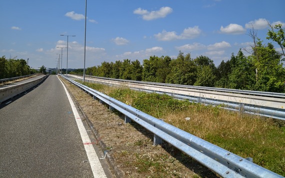 two new lengths of metal barrier installed along either side of the central reservation of a dual carriageway