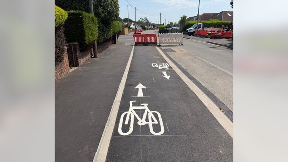 a cycle track in Woodley with bicycle designs painted on the surface facing in opposite directions