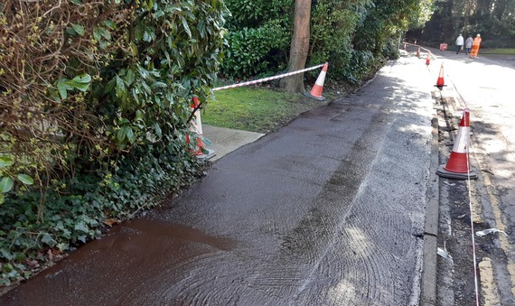 a newly sealed footway with a thin layer of protective slurry over the surface to improve grip