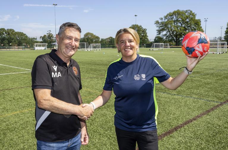 Councillor and BBFA representative shake hands on Cantley Park's 3G pitch to mark a new management partnership.
