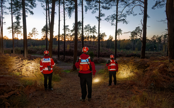 Berkshire Lowland Search and Rescue volunteers searching for someone in a woodland at night