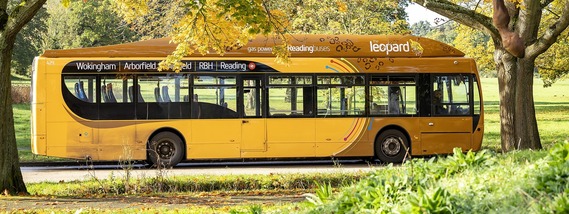 side view of the Leopard 3 bus making its way through Arborfield on a bright autumn day