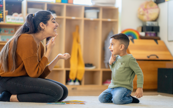 A child and adult practising making a speech sound