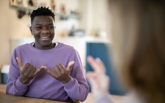 A young person using sign language to communicate