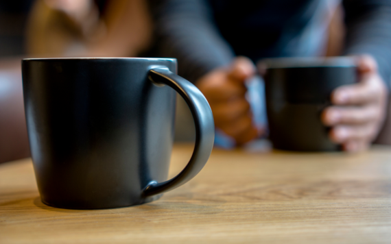 Two mugs on a wooden table