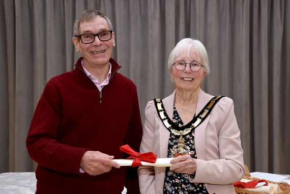 A man, Bob Collis, stands with a mayor as he receives an award