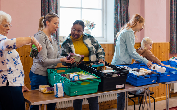 Foodbank volunteers looking through donations