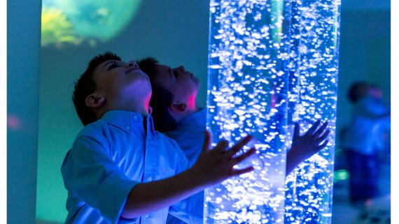 child playing with sensory light