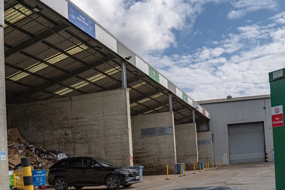 A black car is reversed up to one of the bays at Longshot Lane Recycling Centre in Reading.