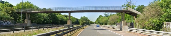 driver's eye view of the footbridge from the A3290, passing over both carriageways