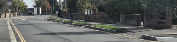 Photo of the road on Woodlands Avenue, with the former dividing line covered up with a new layer of tarmac