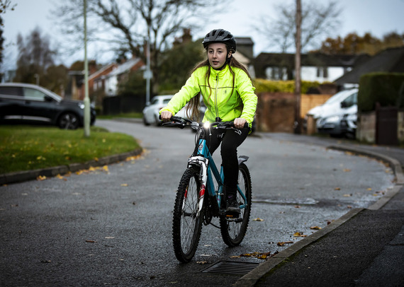 A girl on a bike wearing a hi-vis jacket
