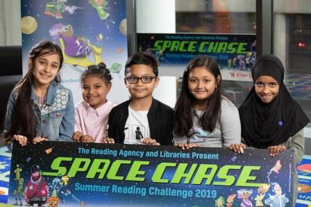 Photo of children holding space chase banner