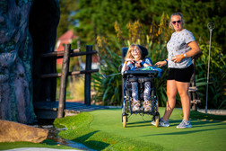 Girl in wheelchair on mini golf course