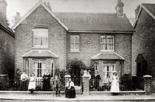 Family standing outside house