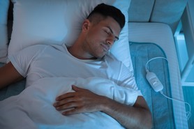 man asleep on electric blanket