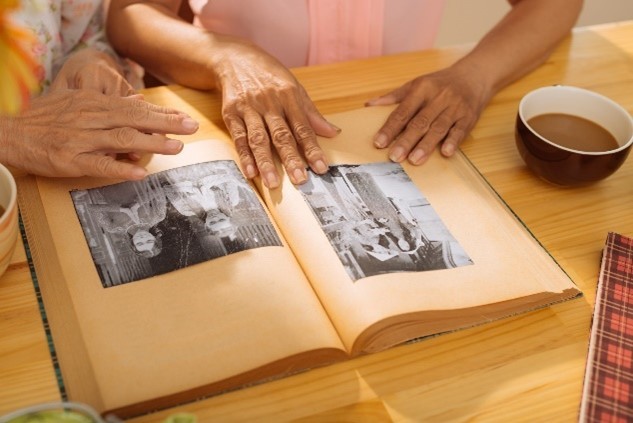 People looking through an old photograph album