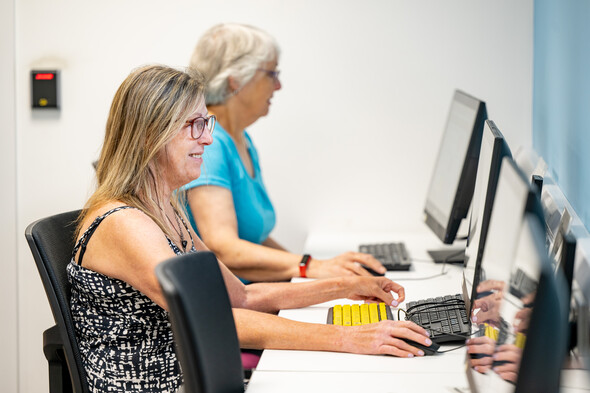 Ladies sitting at a computer