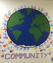 School display board with a picture of the earth and the word 'community'