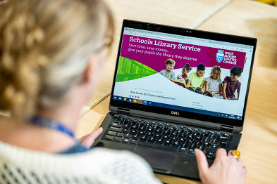 SLS staff member on computer