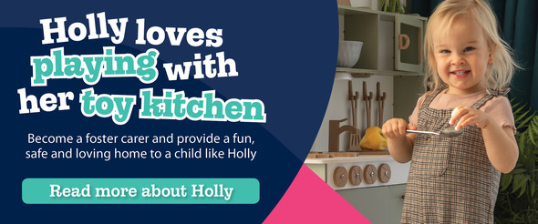 Young girl playing in a toy kitchen