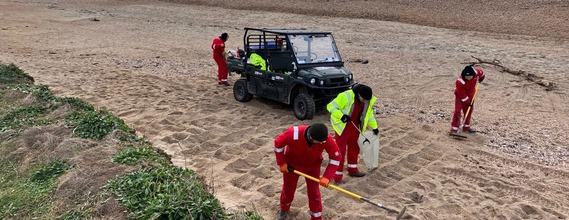 Workers clearing debris from the beach - Op Biblion