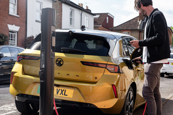 Man charging electric vehicle
