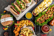 A selection of food, including burgers, hotdogs and chips
