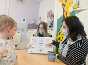 Two speech and language therapists helping a child