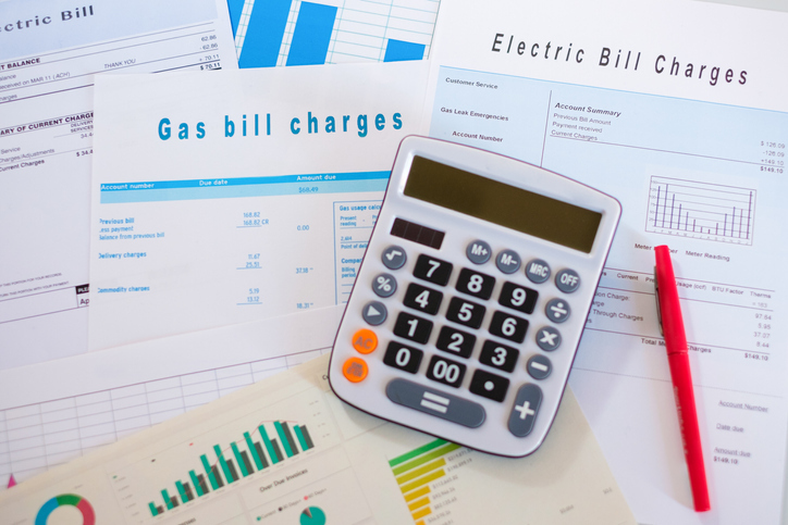 A calculator and various energy bills