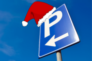 Parking sign with a santa hat